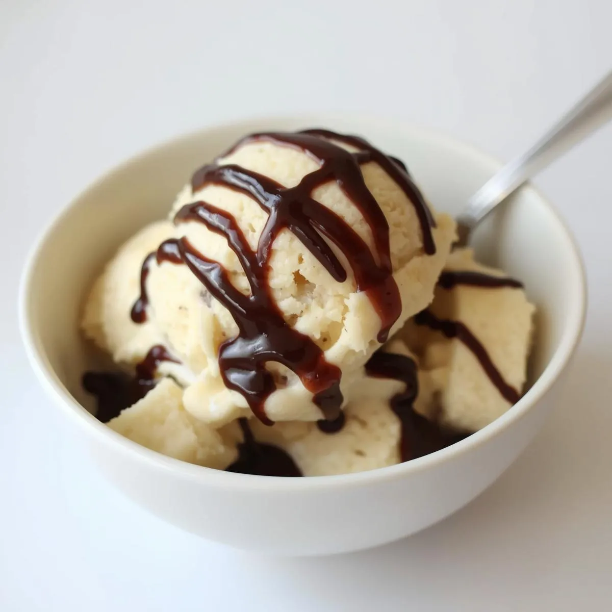 Creamy banana ice cream in a bowl with cocoa drizzle